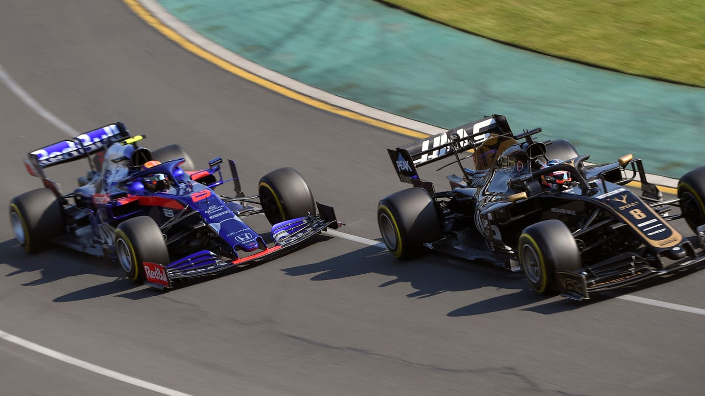 Haas F1 Team's French driver Romain Grosjean leads Toro Rosso's Thai driver Alexander Albon through