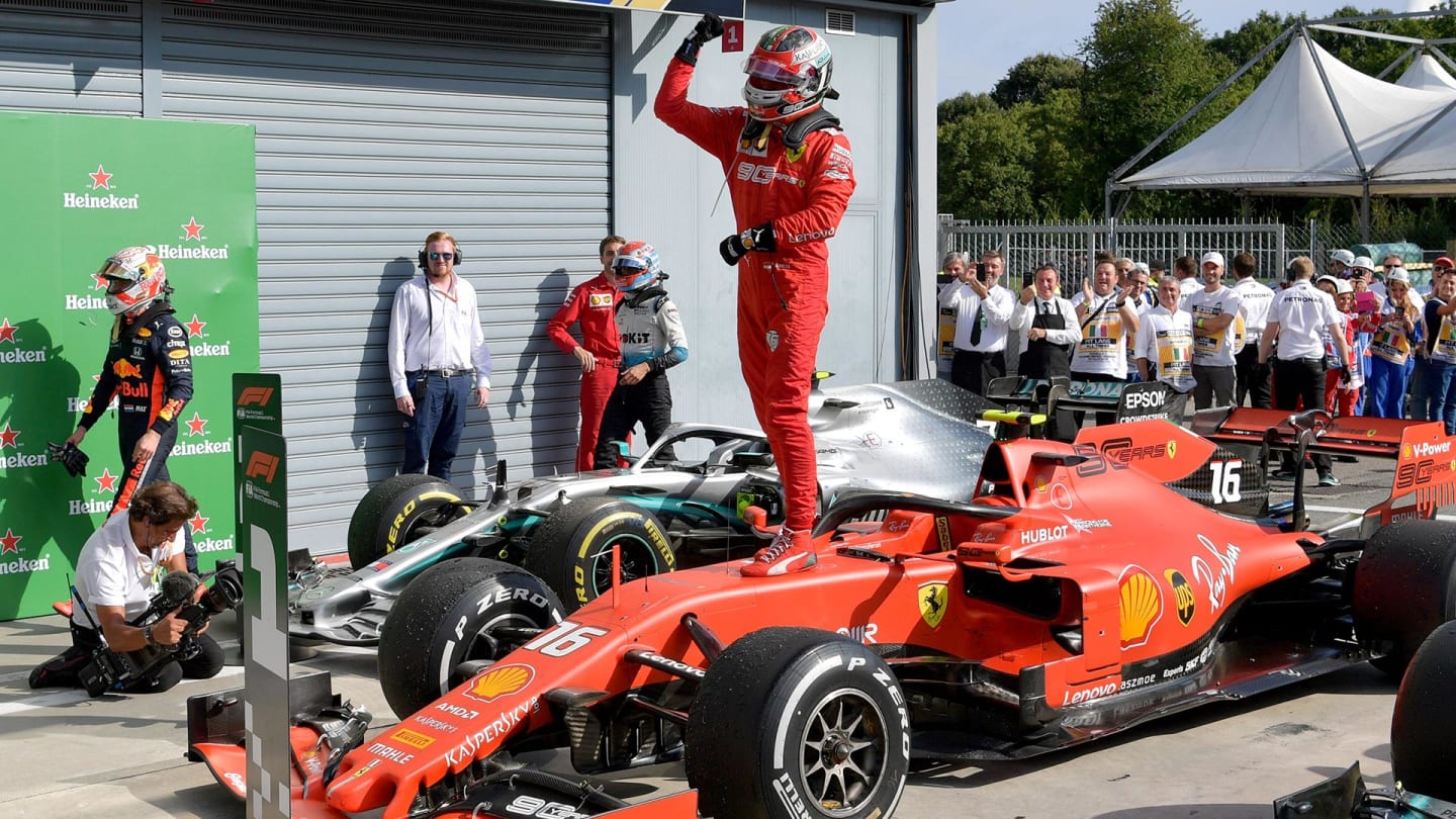 TOPSHOT - Winner Ferrari's Monegasque driver Charles Leclerc stands on his car to celebrate after