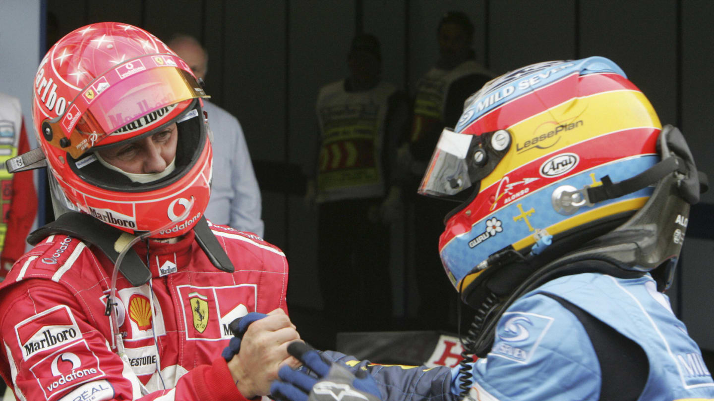 IMOLA, Italy:  Spanish Renault driver Fernando Alonso (R) is congratulated by German Ferrari driver