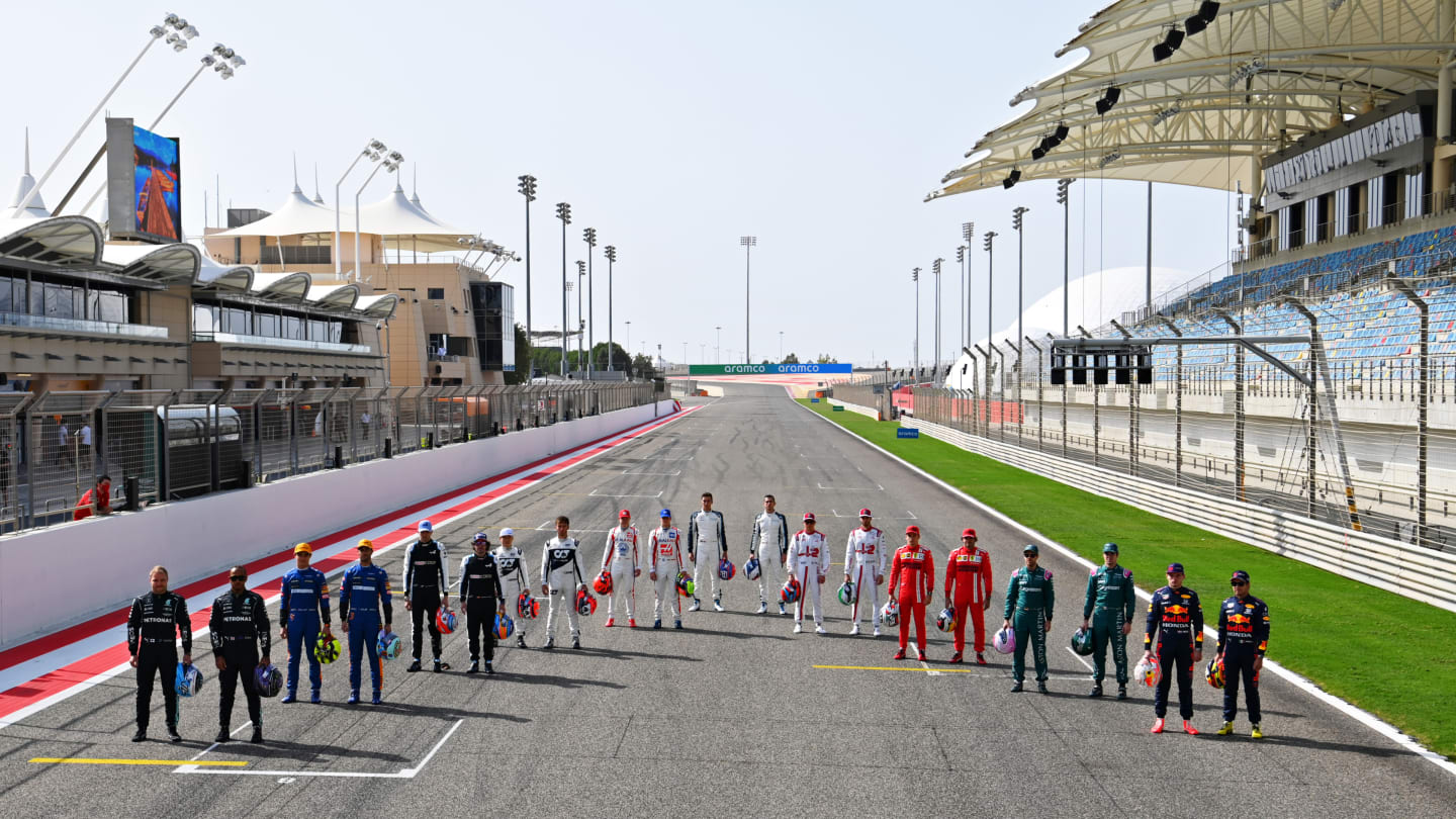 BAHRAIN, BAHRAIN - MARCH 12: The F1 drivers stand on the grid during Day One of F1 Testing at