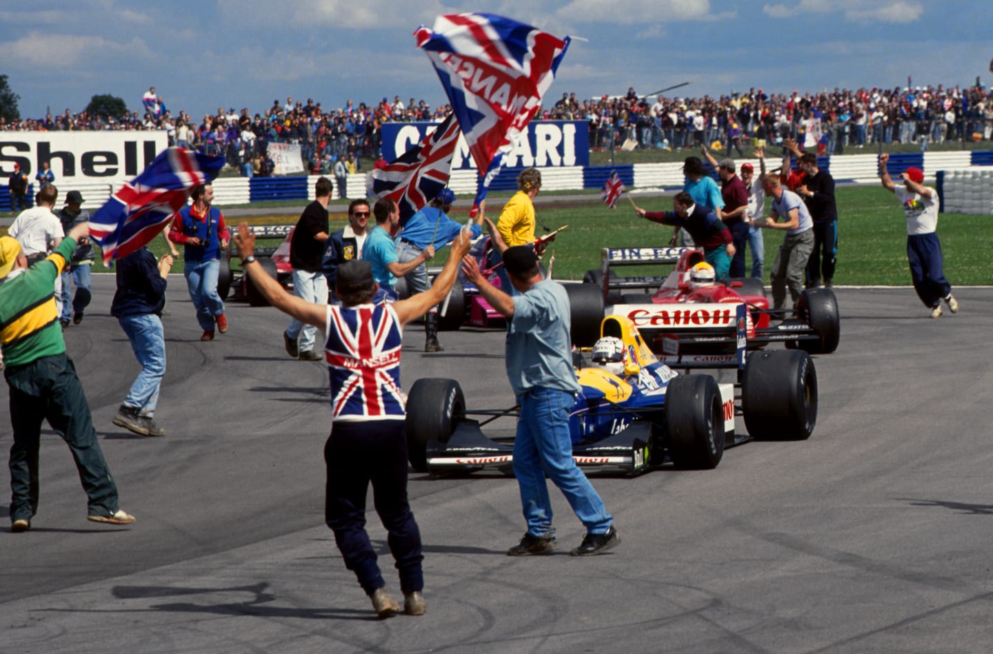 Race winner Nigel Mansell (GBR) Williams Renault FW14B is saluted by fans who have invaded the