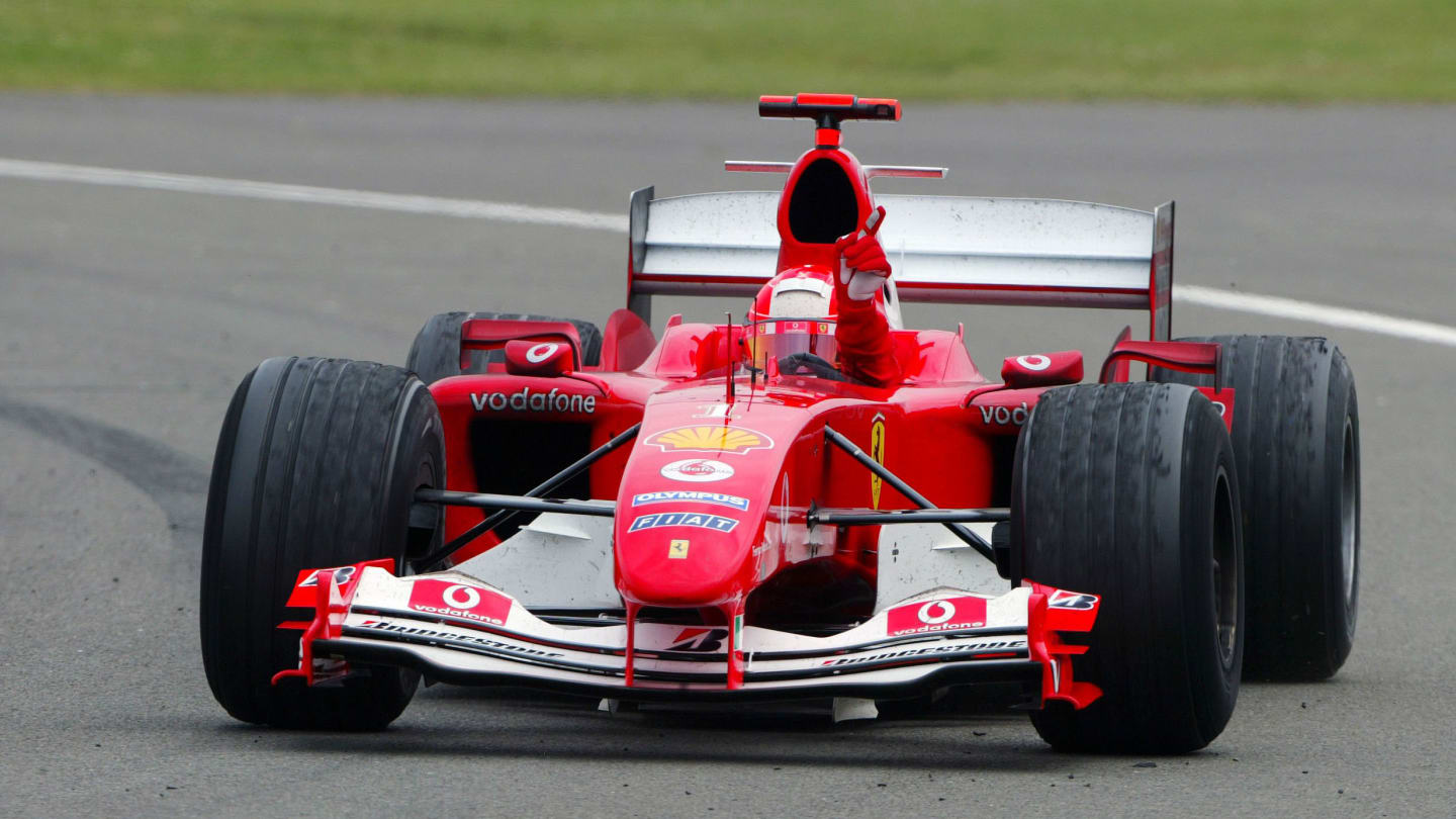 Race winner Michael Schumacher (GER) Ferrari F2004 celebrates his win as he returns to the