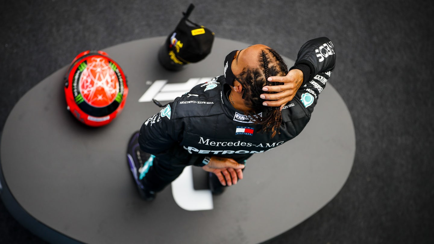 Lewis Hamilton, Mercedes-AMG Petronas F1, 1st position, on the podium with his trophy and the helmet of Michael Schumacher