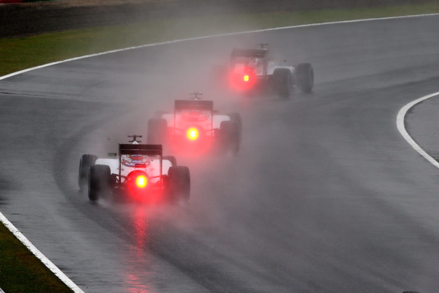 SUZUKA, JAPAN - OCTOBER 05: Drivers compete in atrocious conditions during the Japanese Formula One