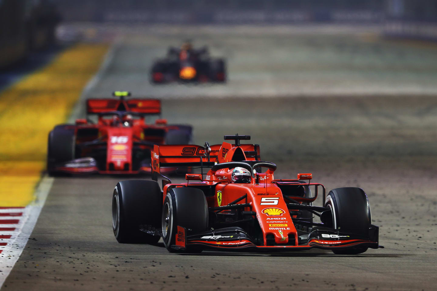 SINGAPORE, SINGAPORE - SEPTEMBER 22: Sebastian Vettel of Germany driving the (5) Scuderia Ferrari SF90 leads Charles Leclerc of Monaco driving the (16) Scuderia Ferrari SF90 on track during the F1 Grand Prix of Singapore at Marina Bay Street Circuit on September 22, 2019 in Singapore. (Photo by Lars Baron/Getty Images)
