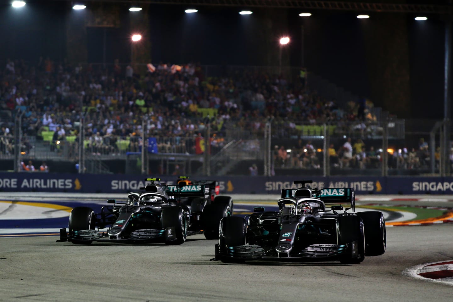 SINGAPORE, SINGAPORE - SEPTEMBER 22: Lewis Hamilton of Great Britain driving the (44) Mercedes AMG Petronas F1 Team Mercedes W10 and Valtteri Bottas driving the (77) Mercedes AMG Petronas F1 Team Mercedes W10 on track during the F1 Grand Prix of Singapore at Marina Bay Street Circuit on September 22, 2019 in Singapore. (Photo by Charles Coates/Getty Images)