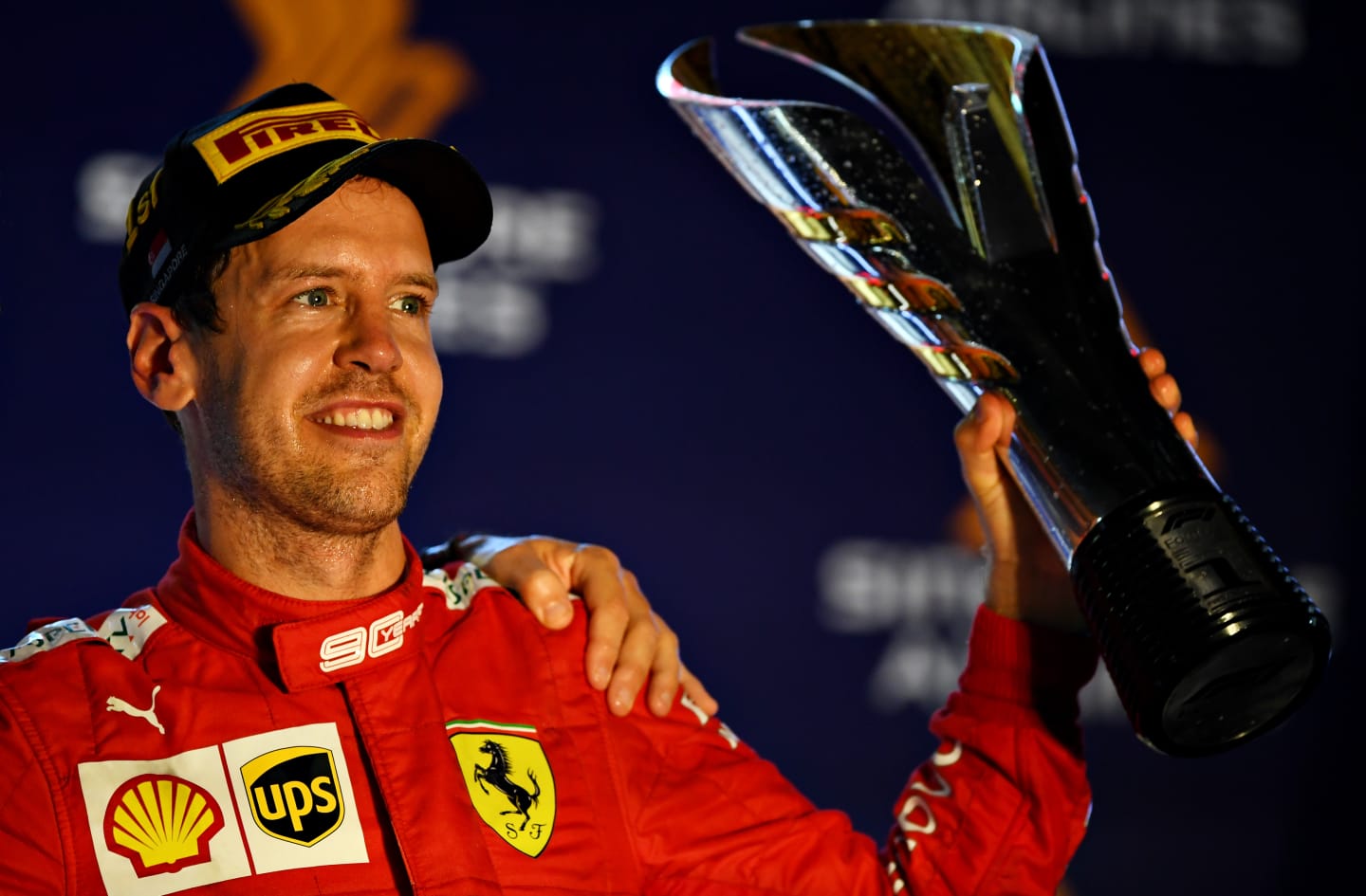 SINGAPORE, SINGAPORE - SEPTEMBER 22: Race winner Sebastian Vettel of Germany and Ferrari celebrates on the podium during the F1 Grand Prix of Singapore at Marina Bay Street Circuit on September 22, 2019 in Singapore. (Photo by Clive Mason/Getty Images)