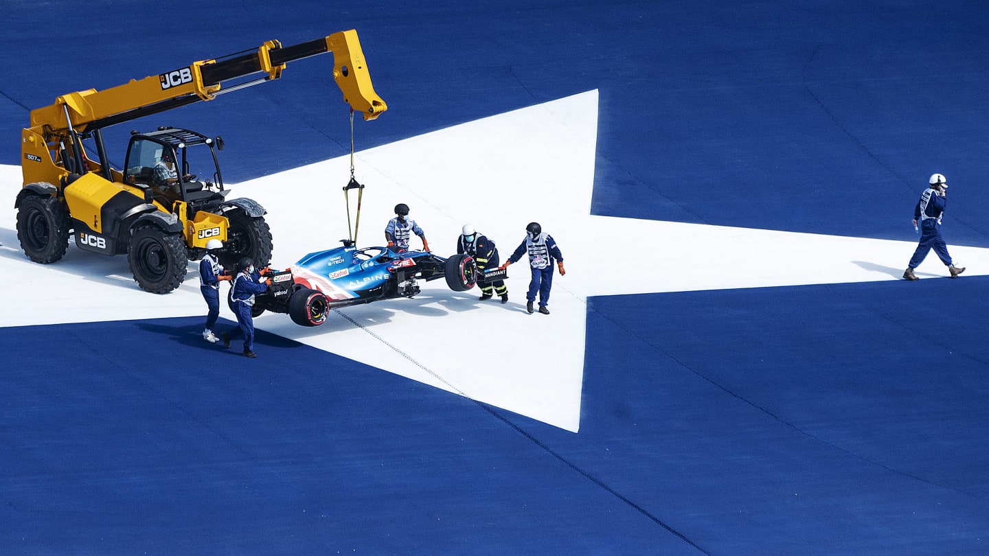 The car of Alpine's Spanish driver Fernando Alonso is taken off the track during the first practice