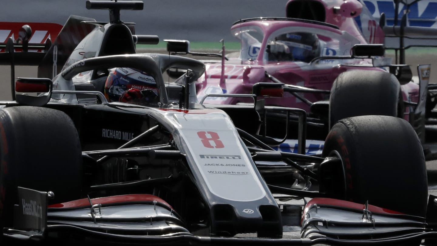 Haas driver Romain Grosjean of France steers his car followed by Racing Point driver Nico