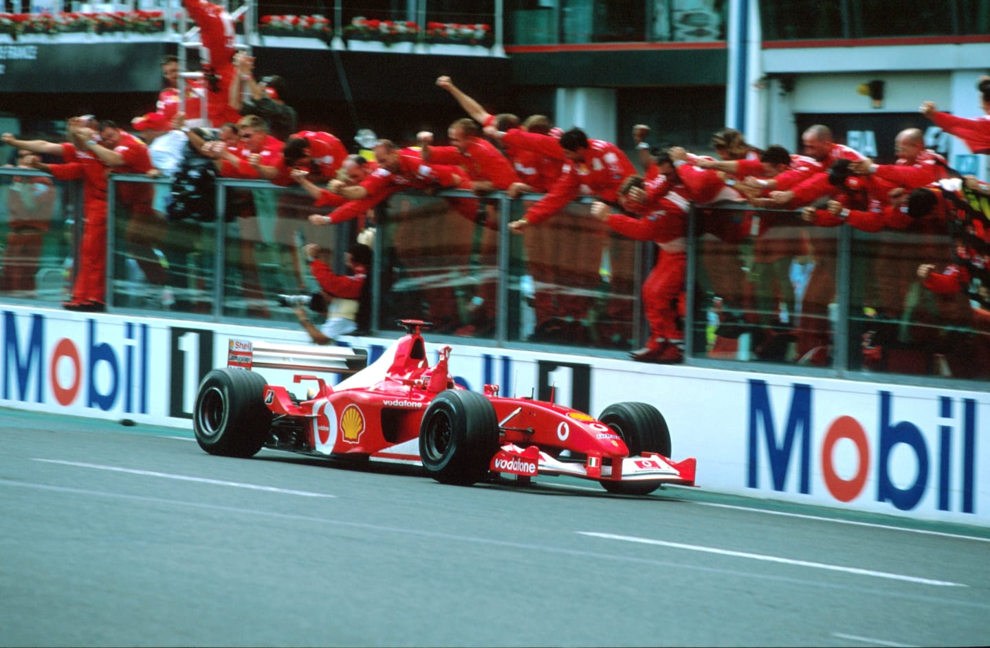 Michael Schumacher (GER) Ferrari F2002, crosses the line to win the race and claim his fifth F1