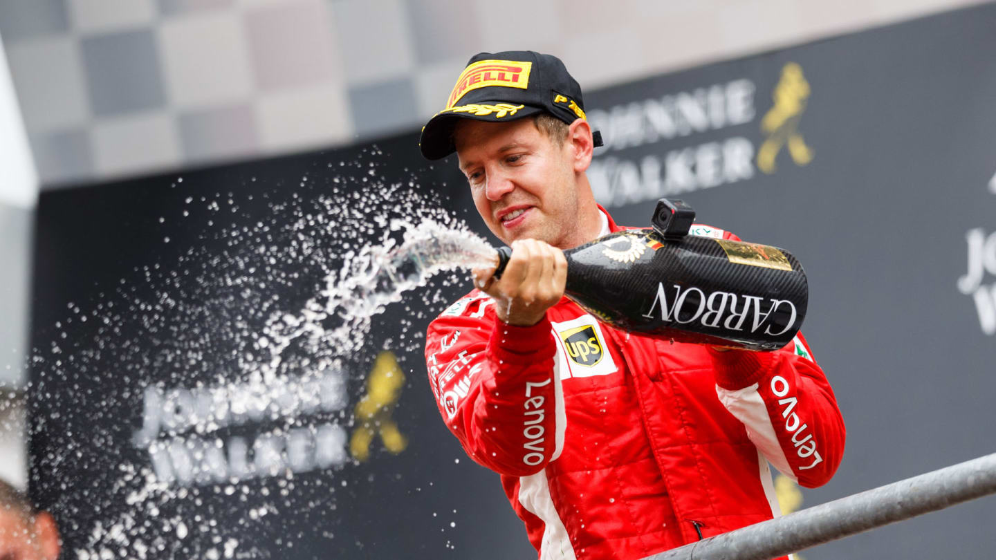 SPA-FRANCORCHAMPS, BELGIUM - AUGUST 23: Sebastian Vettel, Ferrari celebrates with the champagne on