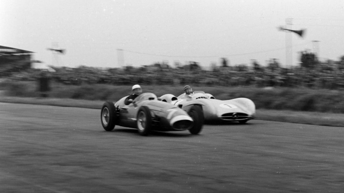 SILVERSTONE, UNITED KINGDOM - JULY 17: Stirling Moss, Maserati 250F, alongside Juan Manuel Fangio,