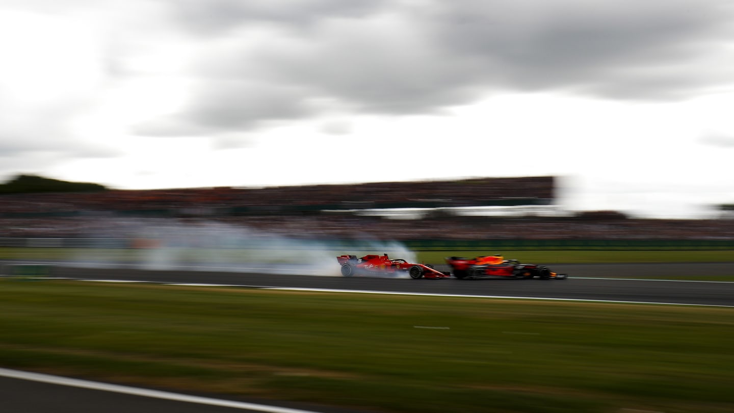 SILVERSTONE, UNITED KINGDOM - JULY 14: Sebastian Vettel, Ferrari locks up and runs into the back of Max Verstappen, Red Bull Racing RB15 during the British GP at Silverstone on July 14, 2019 in Silverstone, United Kingdom. (Photo by Zak Mauger / LAT Images)