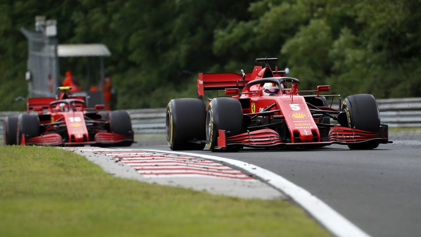 Ferrari driver Sebastian Vettel of Germany steers his car followed by Ferrari driver Charles