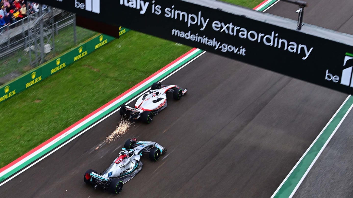 Haas F1 Team's Danish driver Kevin Magnussen (top) and Mercedes' British driver George Russell steer during the Emilia Romagna Formula One Grand Prix at the Autodromo Internazionale Enzo e Dino Ferrari race track in Imola, Italy, on April 24, 2022. (Photo by ANDREJ ISAKOVIC / AFP) (Photo by ANDREJ ISAKOVIC/AFP via Getty Images)