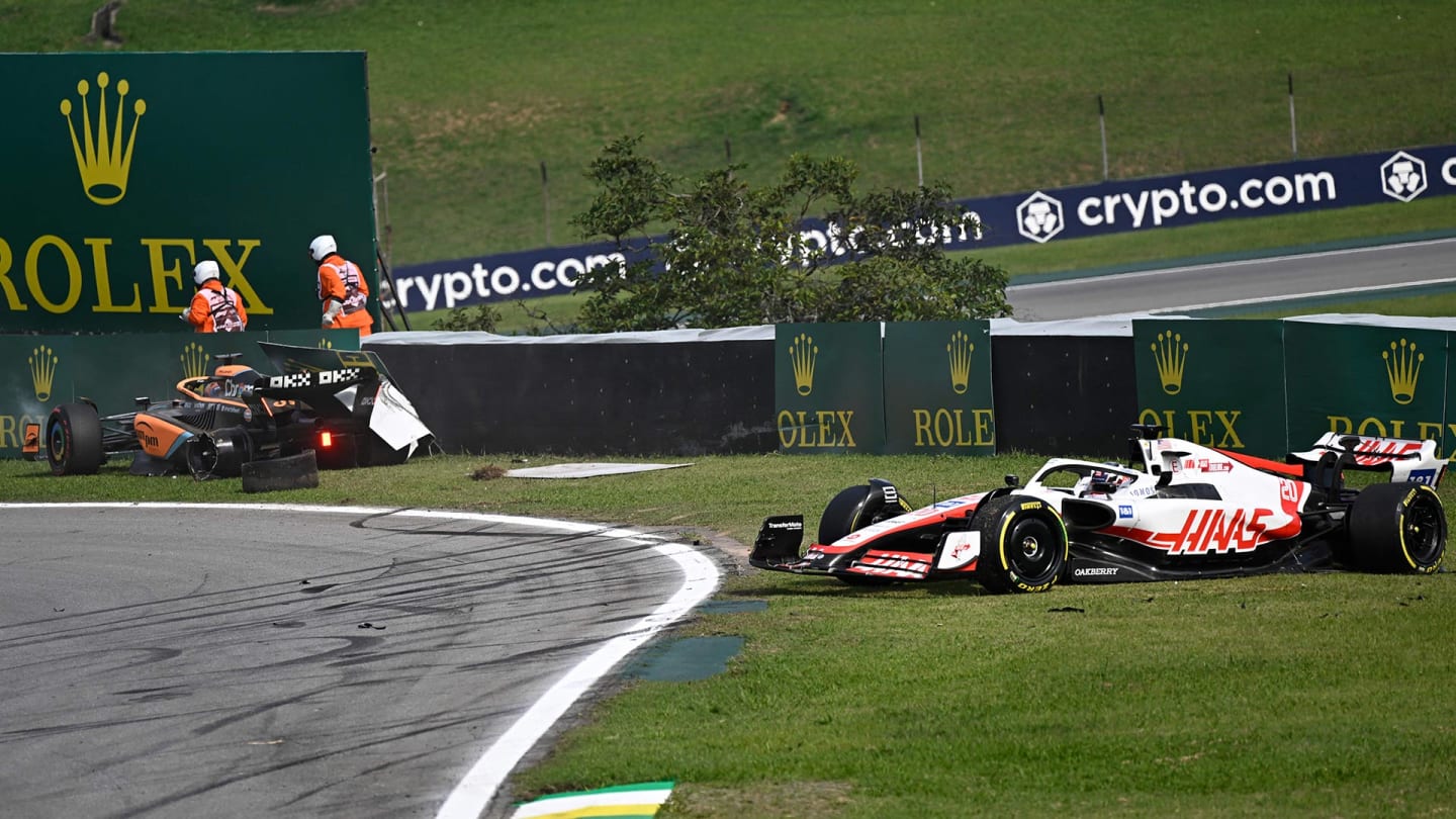McLaren's Australian driver Daniel Ricciardo (L) and Haas F1 Team's Danish driver Kevin Magnussen go off the track after crashing during the Formula One Brazil Grand Prix at the Autodromo Jose Carlos Pace racetrack, also known as Interlagos, in Sao Paulo, Brazil, on November 13, 2022. (Photo by MAURO PIMENTEL / AFP) (Photo by MAURO PIMENTEL/AFP via Getty Images)