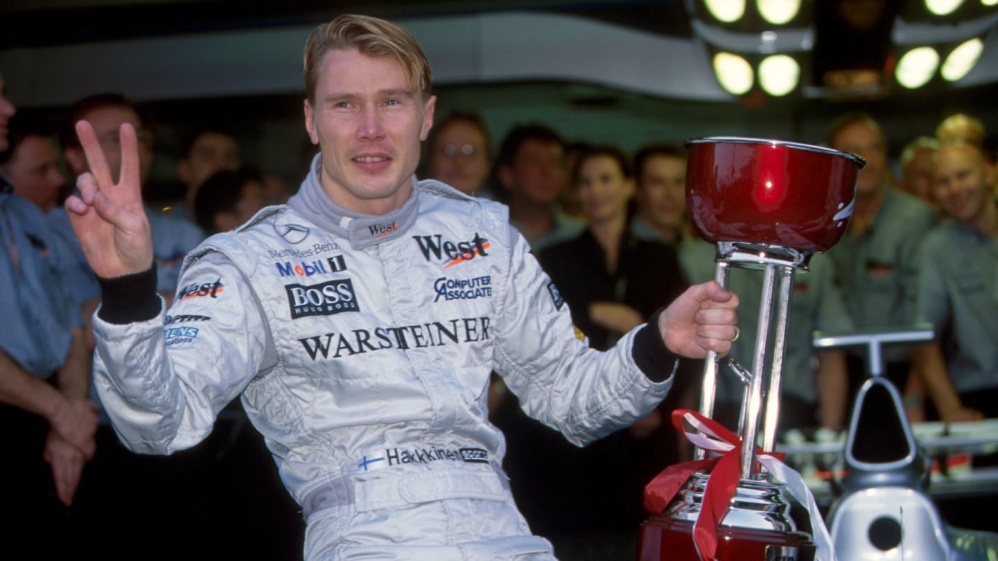 Mika Hakkinen (FIN), McLaren MP4-13, celebrates winning the race and his first World