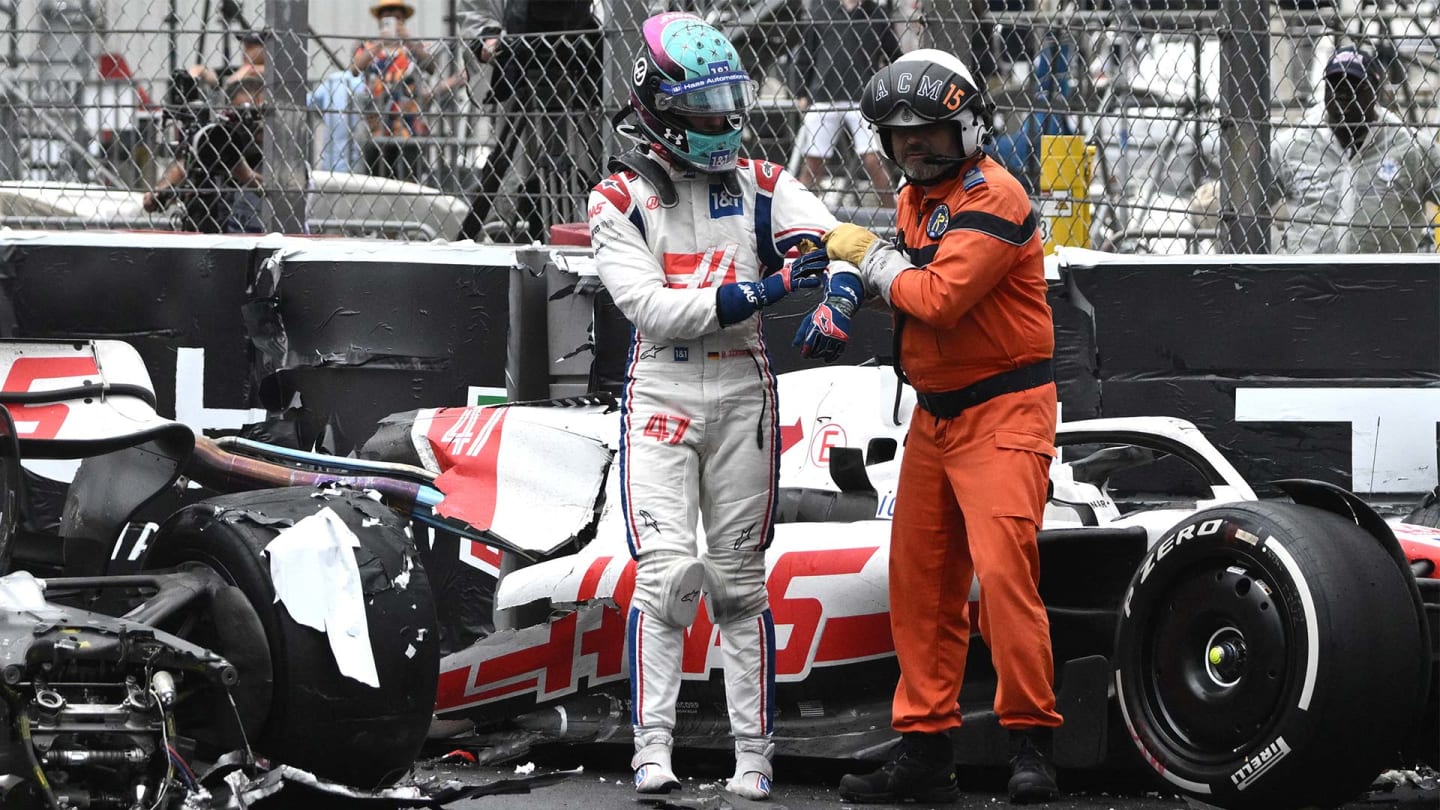 Haas F1 Team's German driver Mick Schumacher (L) is asisted by a race marshal after crashing during the Monaco Formula 1 Grand Prix at the Monaco street circuit in Monaco, on May 29, 2022. (Photo by LOIC VENANCE / AFP) (Photo by LOIC VENANCE/AFP via Getty Images)