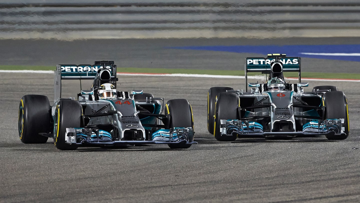 SAKHIR, BAHRAIN - APRIL 06:  Lewis Hamilton (L) of Great Britain and Mercedes GP leads from team