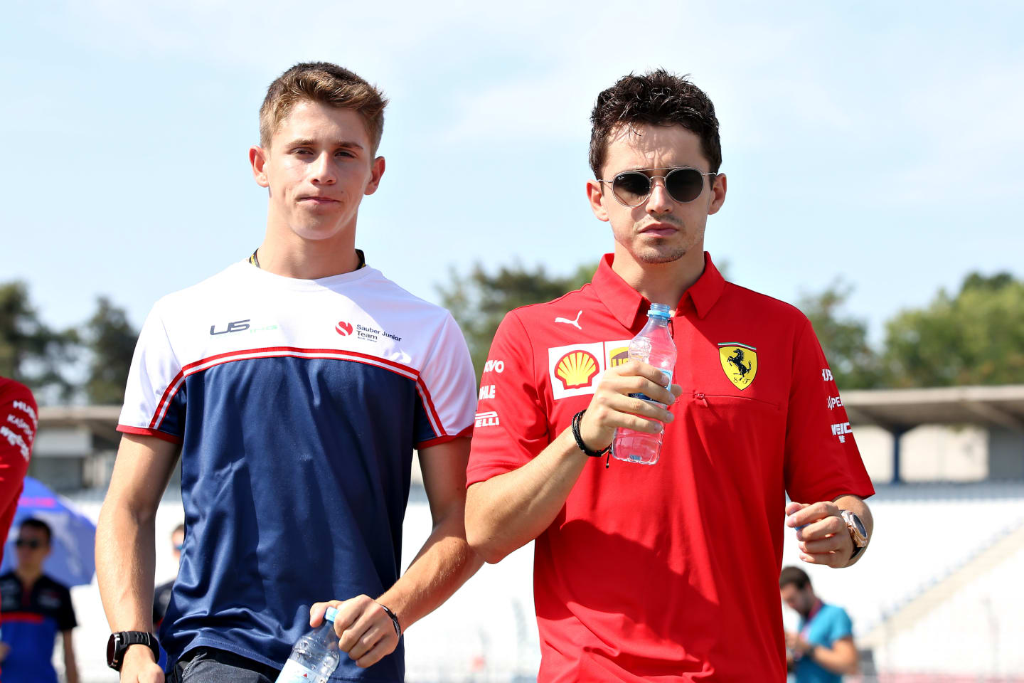 HOCKENHEIM, GERMANY - JULY 25: Charles Leclerc of Monaco and Ferrari walks the track with brother