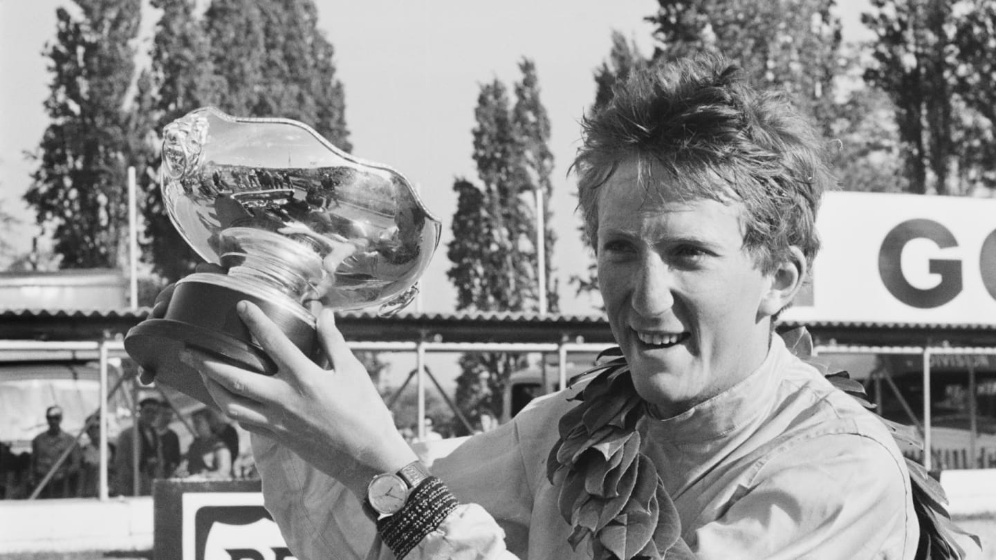 German racing driver Jochen Rindt (1942 - 1970) holding his trophy after winning the 'London