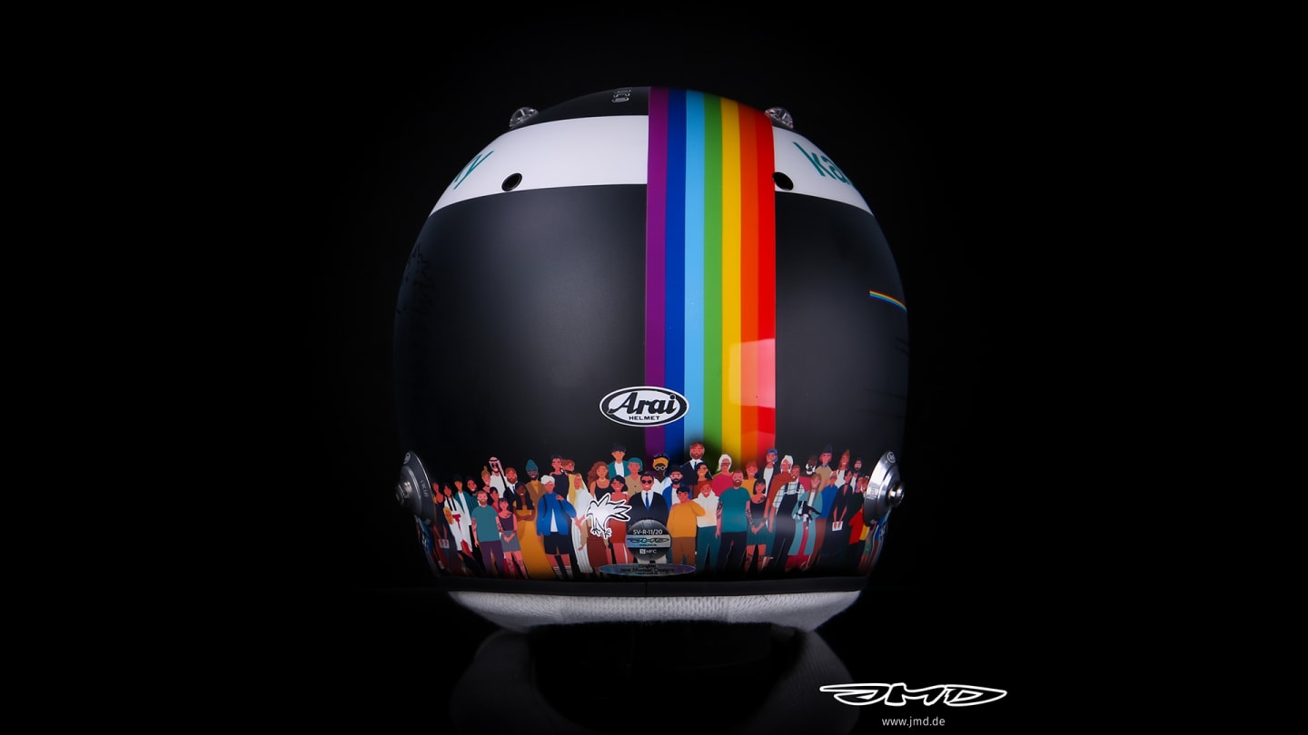 The back of Vettel's helmet shows the glossy rainbow graphic with the crowd of people below