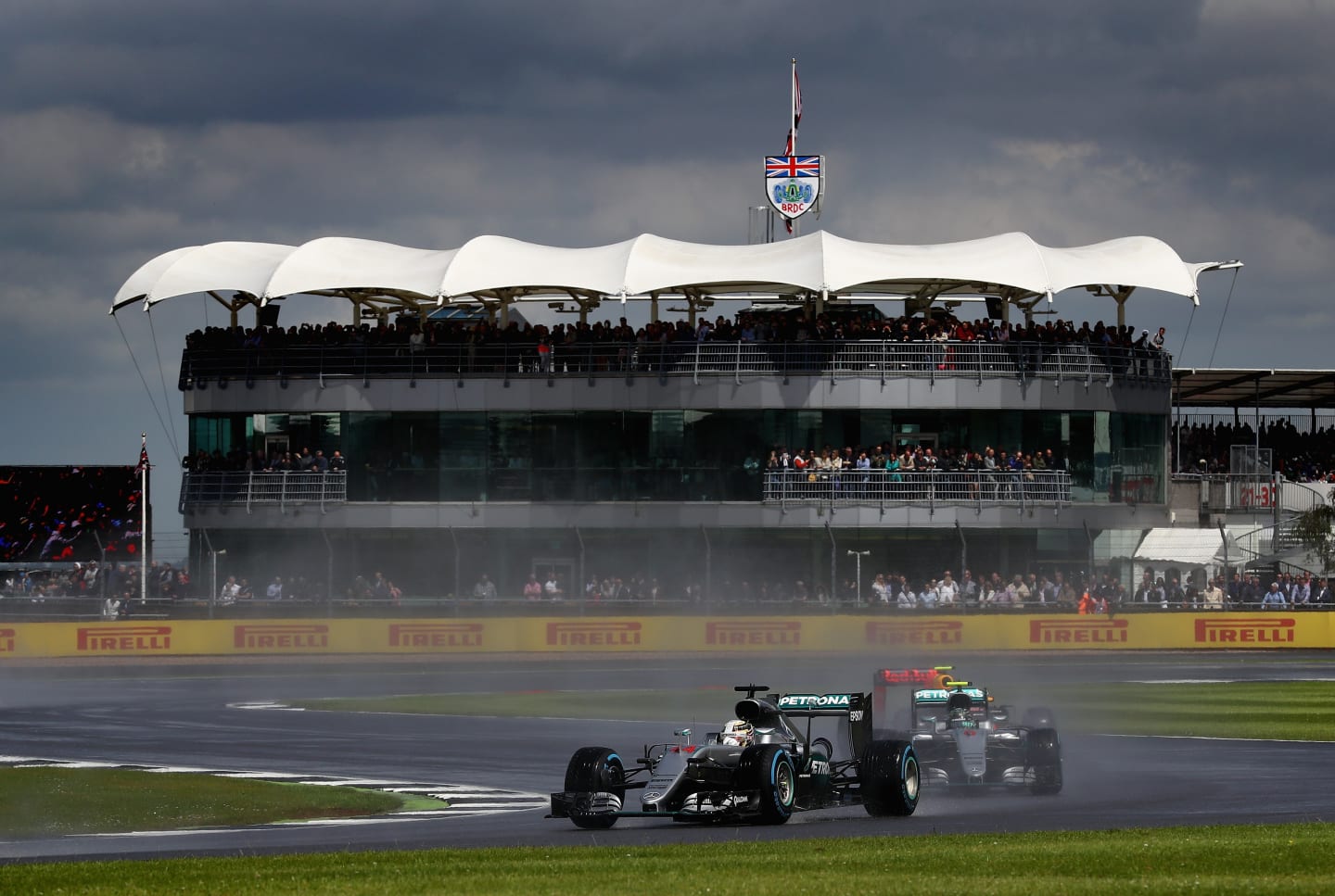 NORTHAMPTON, ENGLAND - JULY 10:  Lewis Hamilton of Great Britain and Mercedes GP leads team mate