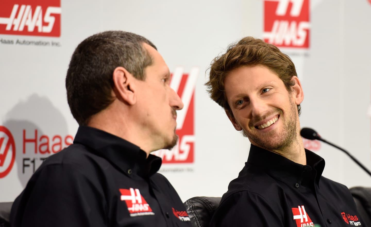 KANNAPOLIS, NC - SEPTEMBER 29:  Romain Grosjean of France looks on as Gunther Steiner, team