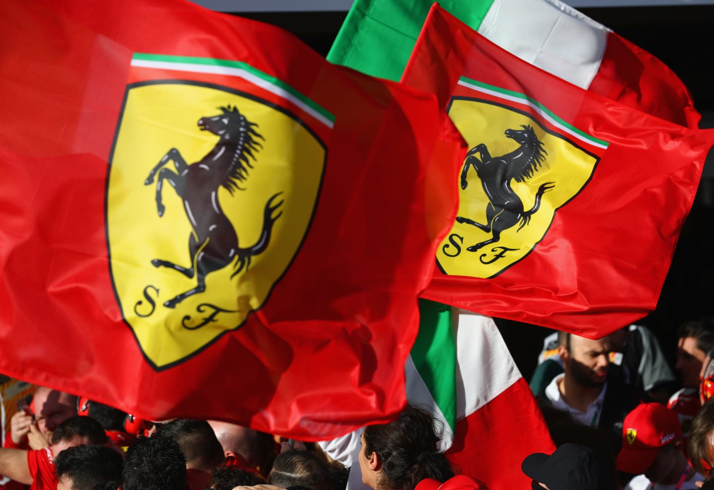 MELBOURNE, AUSTRALIA - MARCH 25: The Ferrari team wave flags at the podium during the Australian