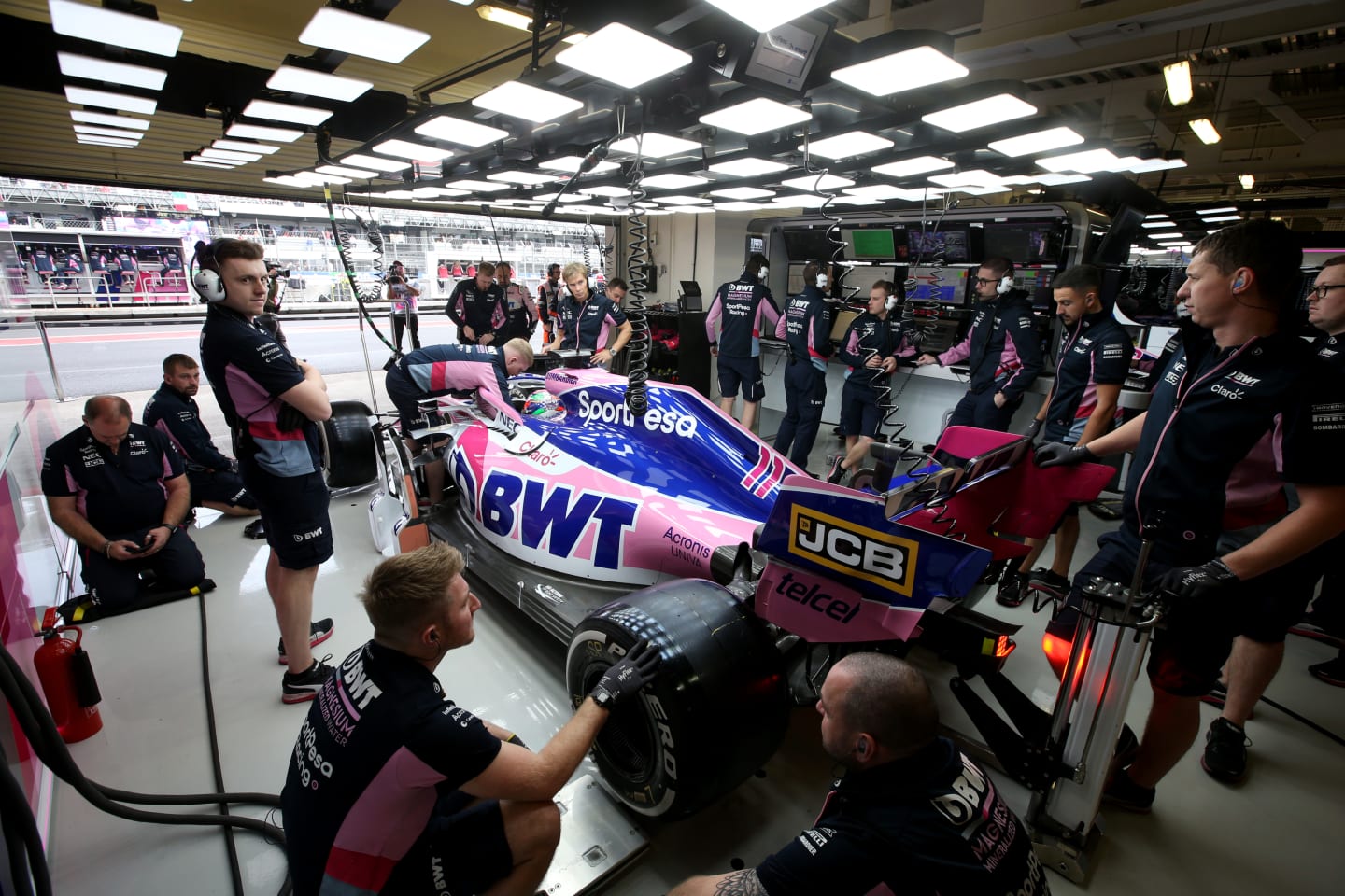 MEXICO CITY, MEXICO - OCTOBER 26: The Racing Point team work in the garage during final practice