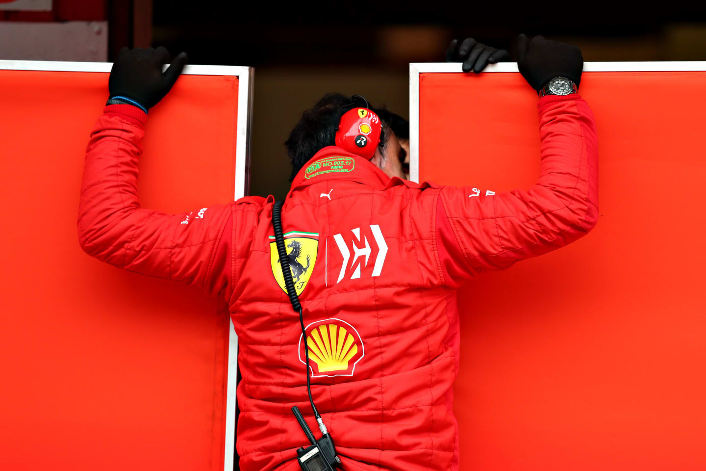 MONTMELO, SPAIN - FEBRUARY 20: A Ferrari team member looks through the screens into their garage