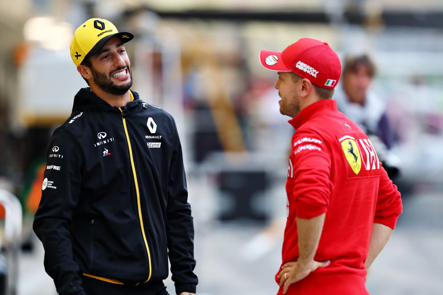 SUZUKA, JAPAN - OCTOBER 11: Sebastian Vettel of Germany and Ferrari and Daniel Ricciardo of