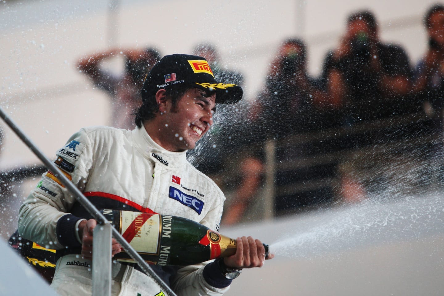 KUALA LUMPUR, MALAYSIA - MARCH 25:  Sergio Perez of Mexico and Sauber F1 celebrates on the podium