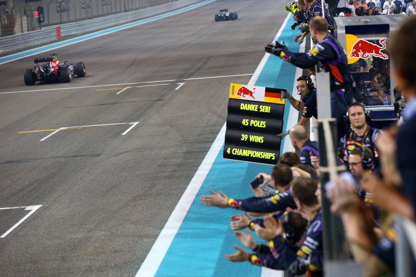 ABU DHABI, UNITED ARAB EMIRATES - NOVEMBER 23:  Members of the Infiniti Red Bull Racing team cheer