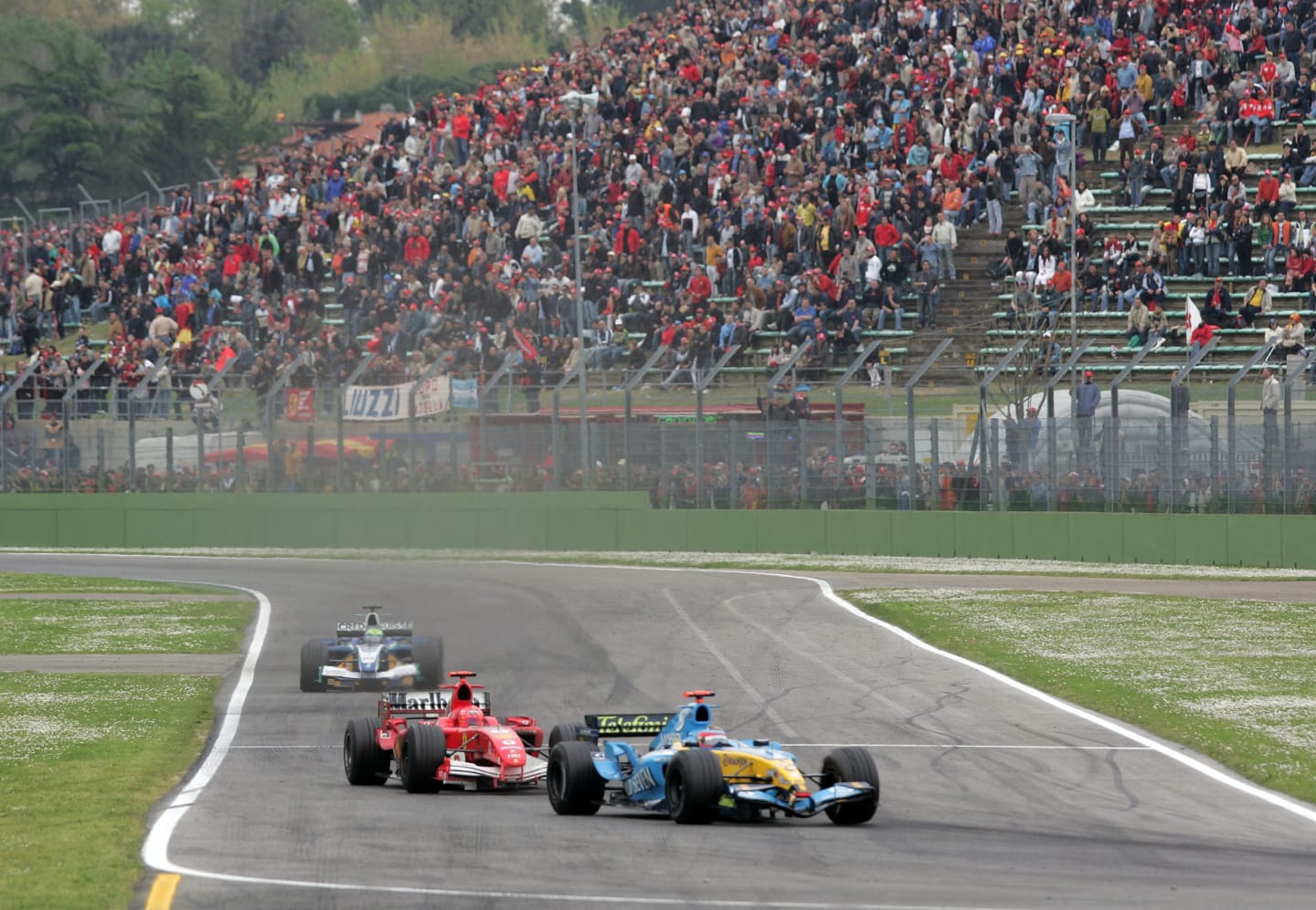 IMOLA, ITALY - APRIL 24:  Fernando Alonso of Spain and Renault leads Michael Schumacher of Germany