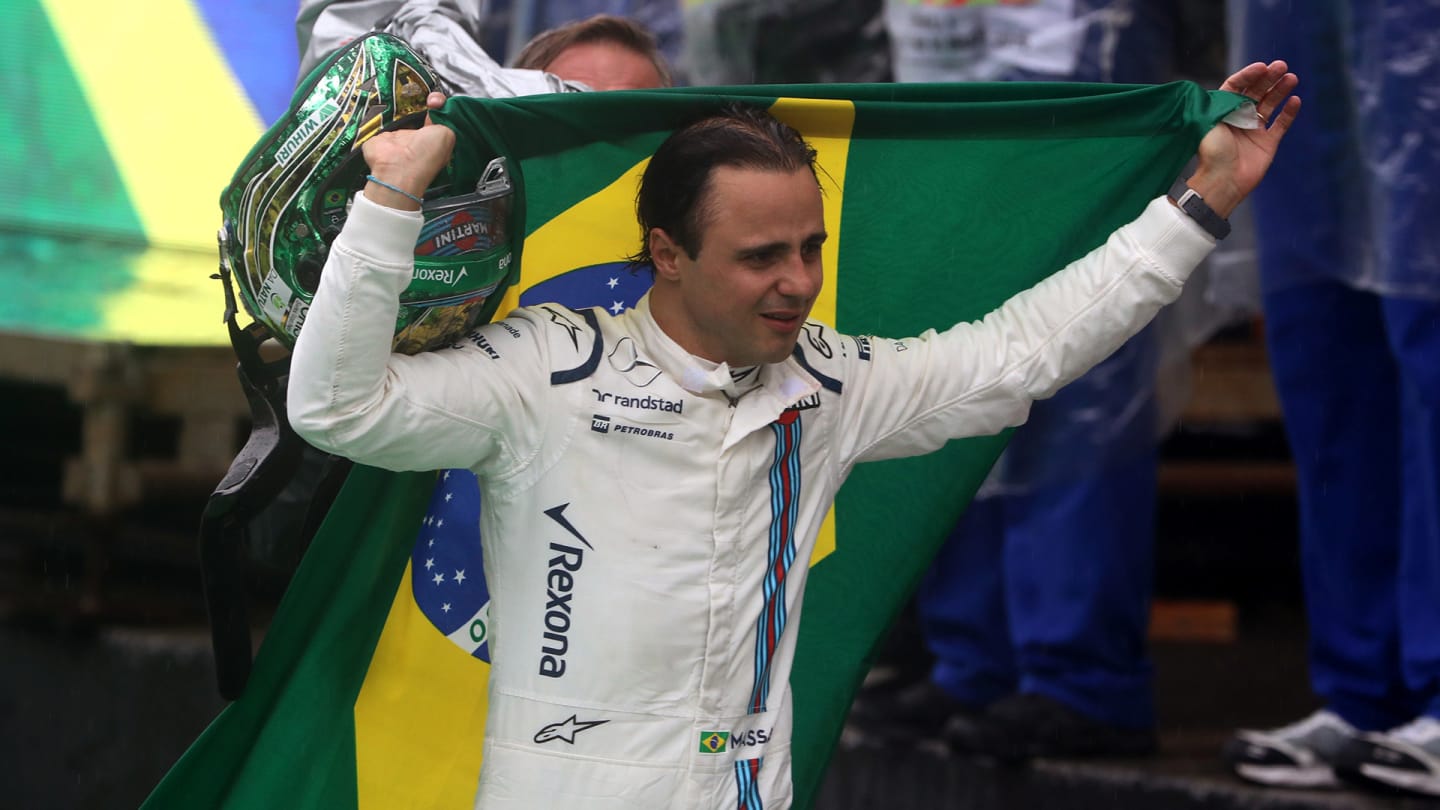 Tearful Williams Martini Racing's Brazilian driver Felipe Massa, wrapped in his country's flag, is