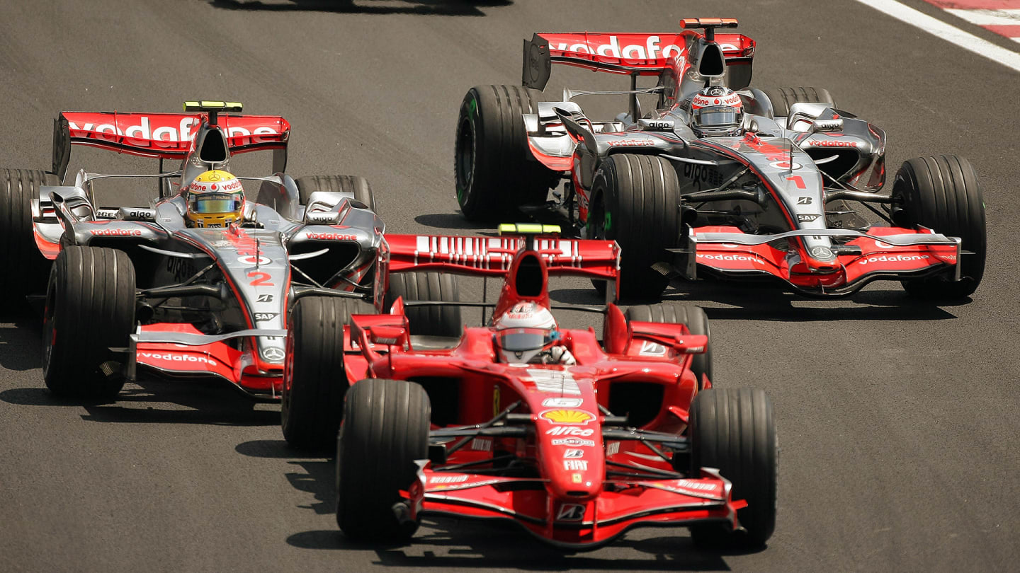 Finnish F1 driver Kimi Raikkonen (front) powers his Ferrari in the second place at the start,