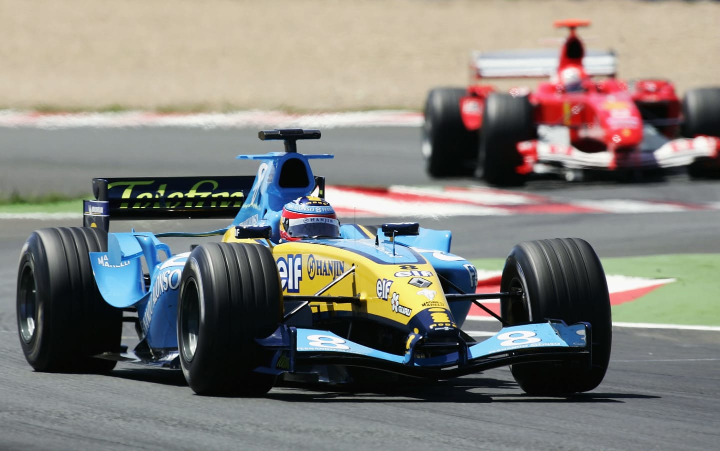 MAGNY-COURS, FRANCE - JULY 4: Fernando Alonso of Spain and Renault leads Michael Schumacher of