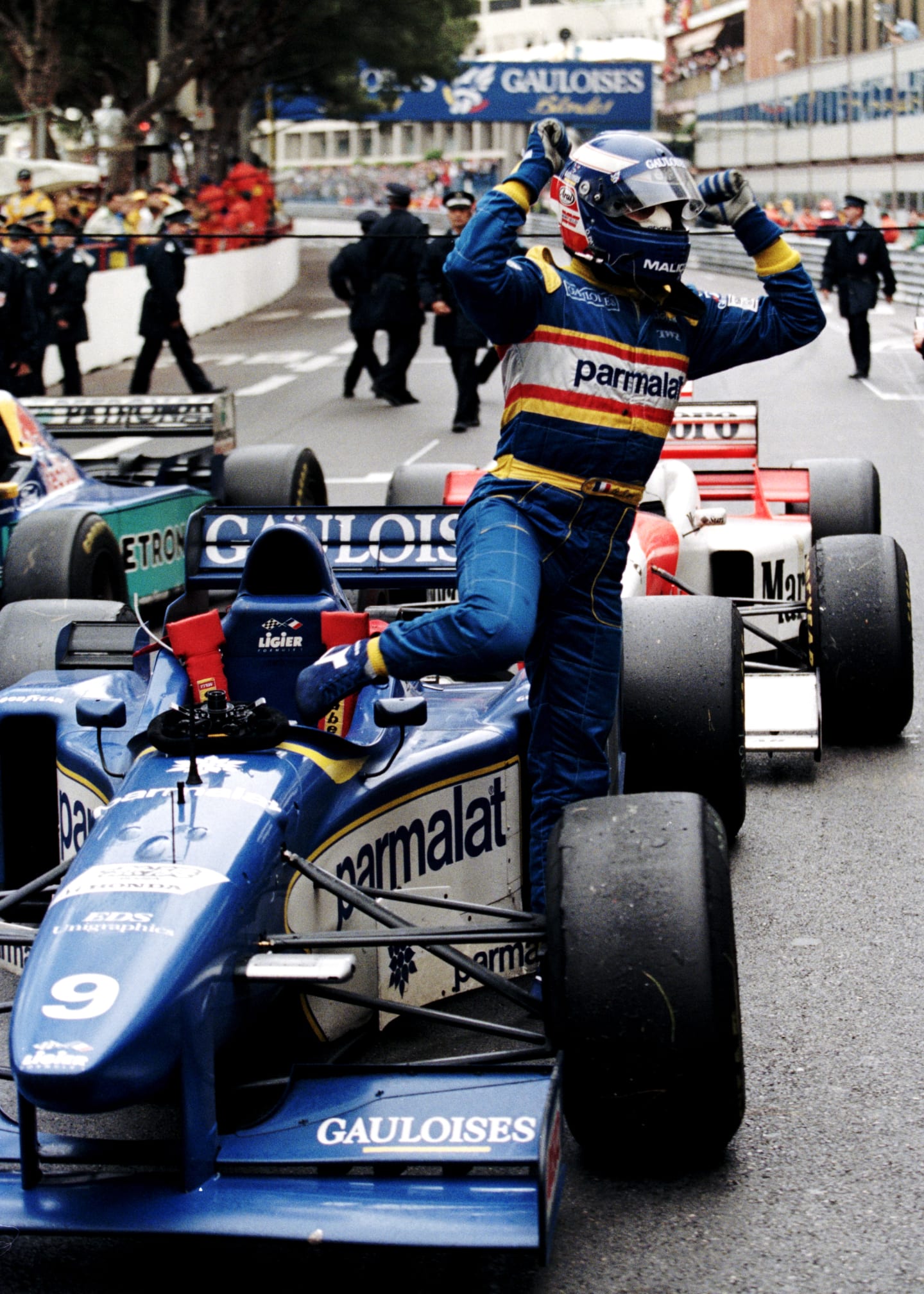 Olivier Panis with arms aloft climbs from his #9 Equipe Ligier Gauloises Blondes Ligier JS43