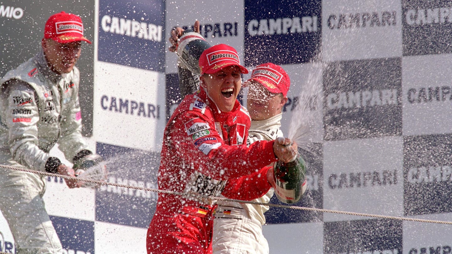 10 Sep 2000: Michael Schumacher (red clothing) of Germany and Ferrari celebrates victory after the