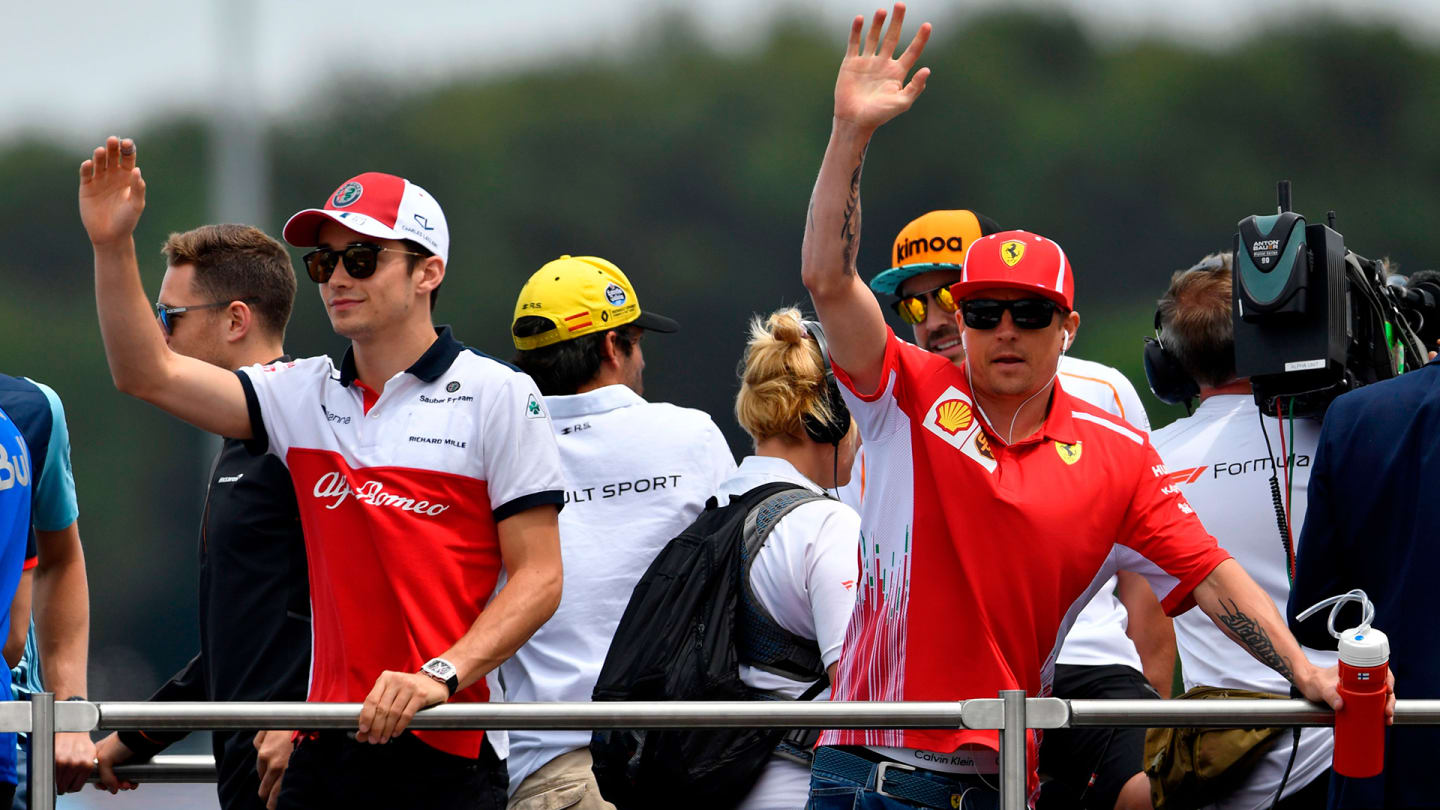 Ferrari's Finnish driver Kimi Raikkonen (R) and Sauber F1's Monegasque driver Charles Leclerc (L)