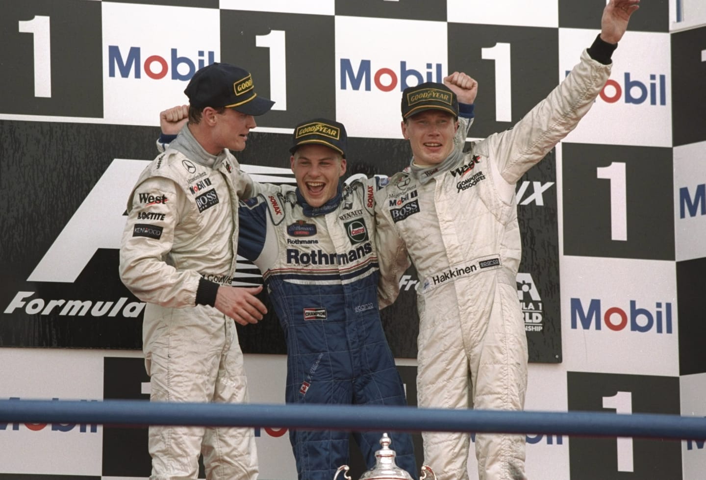 26 Oct 1997:  Williams Renault driver Jacques Villeneuve (centre) of Canada celebrates becoming