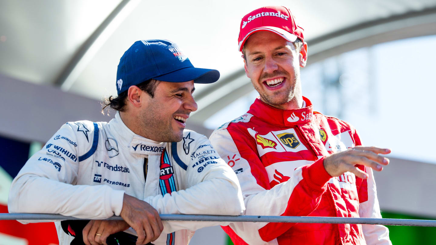 MONZA, ITALY - SEPTEMBER 06:  Felipe Massa of Williams and Brazil chats with Sebastian Vettel of