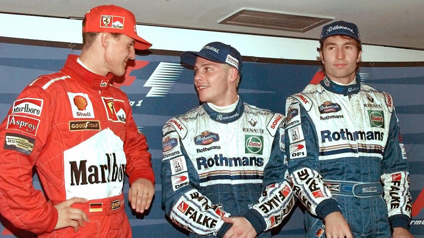 German Ferrari driver Michael Schumacher and Canadian Williams-Renault Jacques Villeneuve grin at