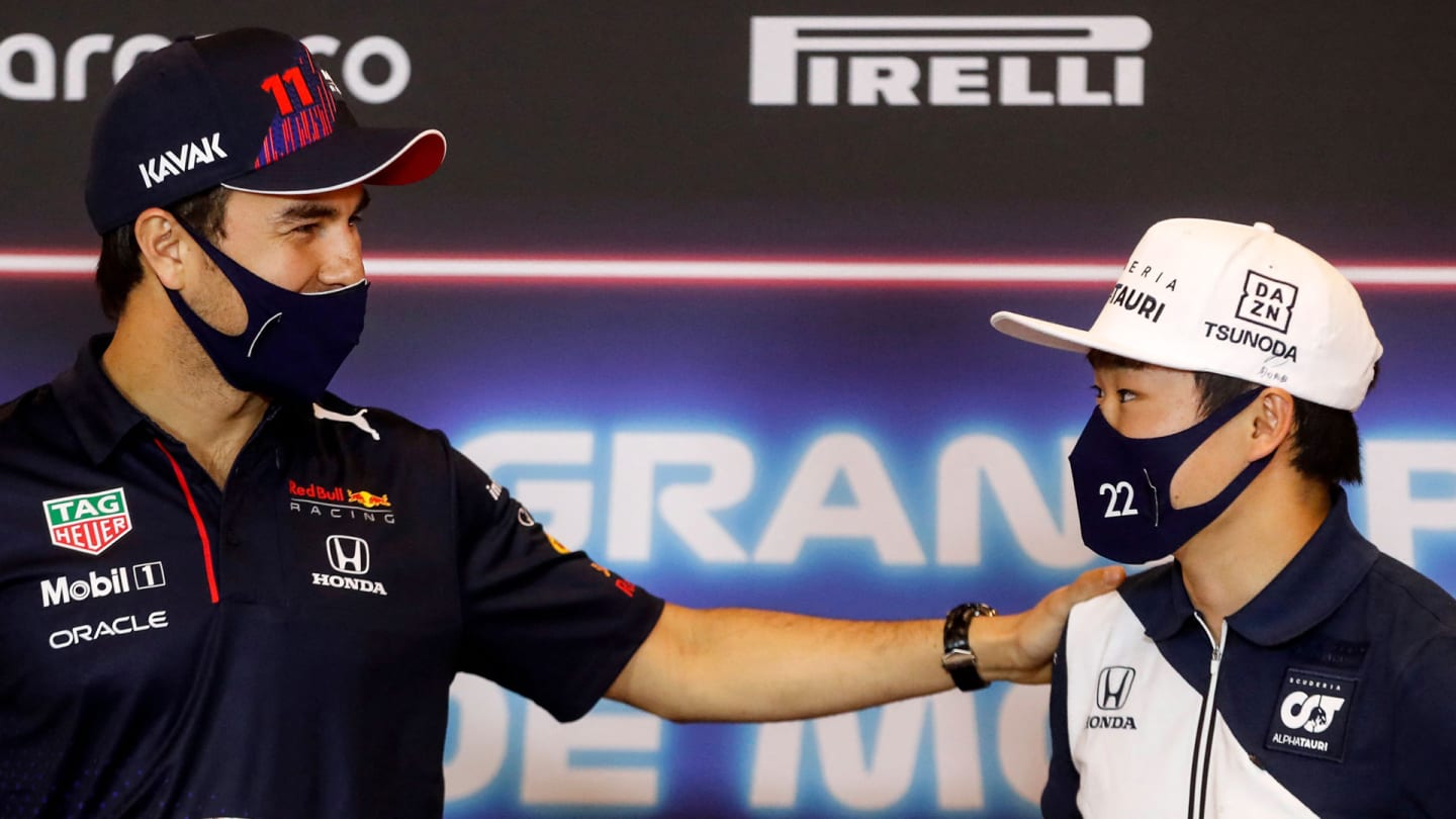 Red Bull's Mexican driver Sergio Perez (L) greets AlphaTauri's Japanese driver Yuki Tsunoda (R)
