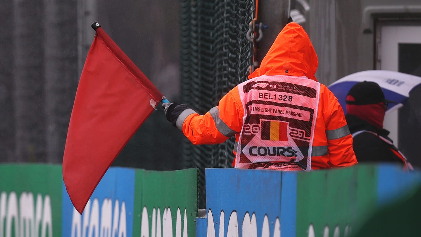 SPA, BELGIUM - AUGUST 29: A track marshal waves a red flag to signal the suspension of the race
