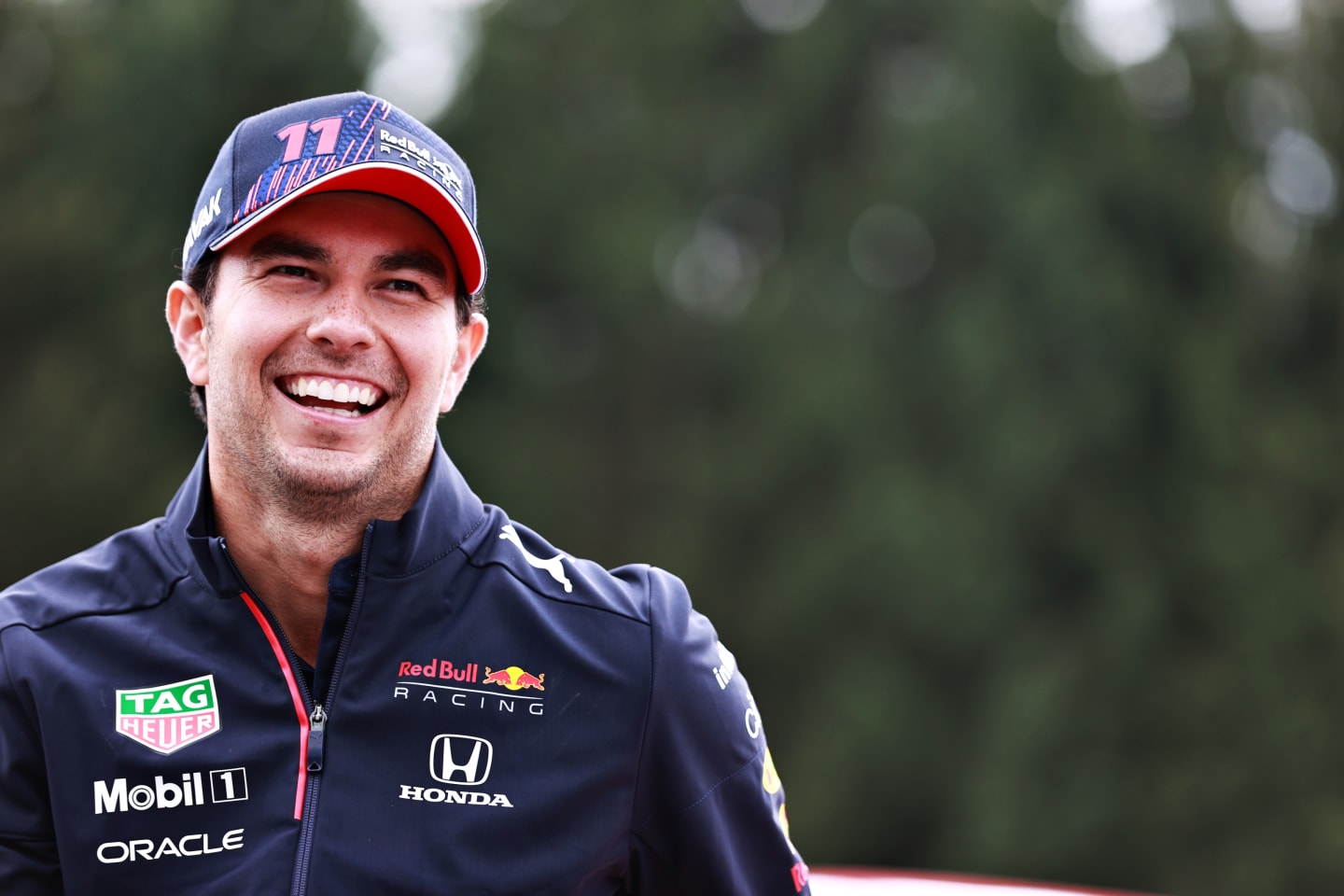 SPA, BELGIUM - AUGUST 26: Sergio Perez of Mexico and Red Bull Racing looks on in the Paddock during