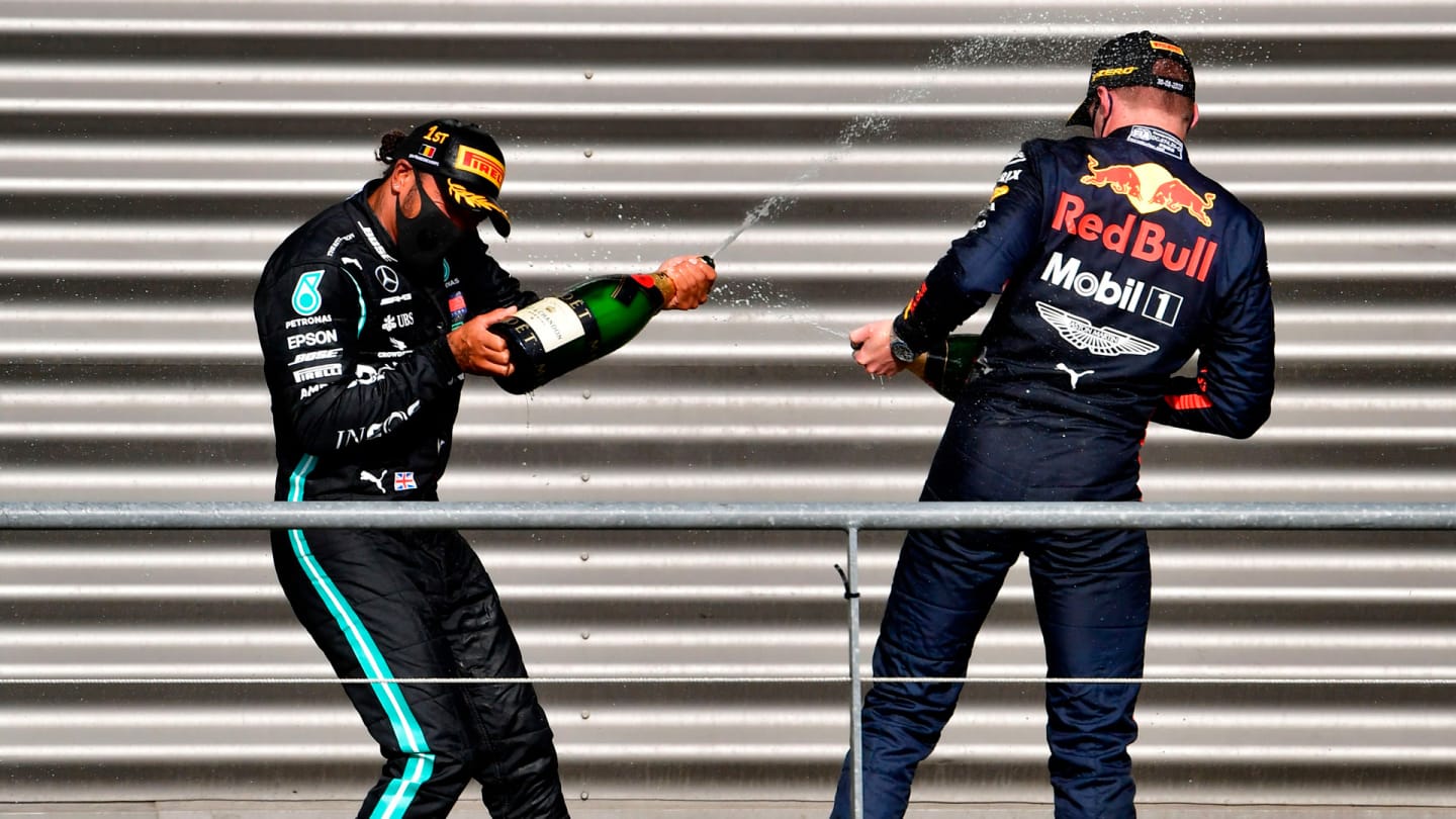 Winner Mercedes' British driver Lewis Hamilton (L) celebrates on the podium with third placed Red