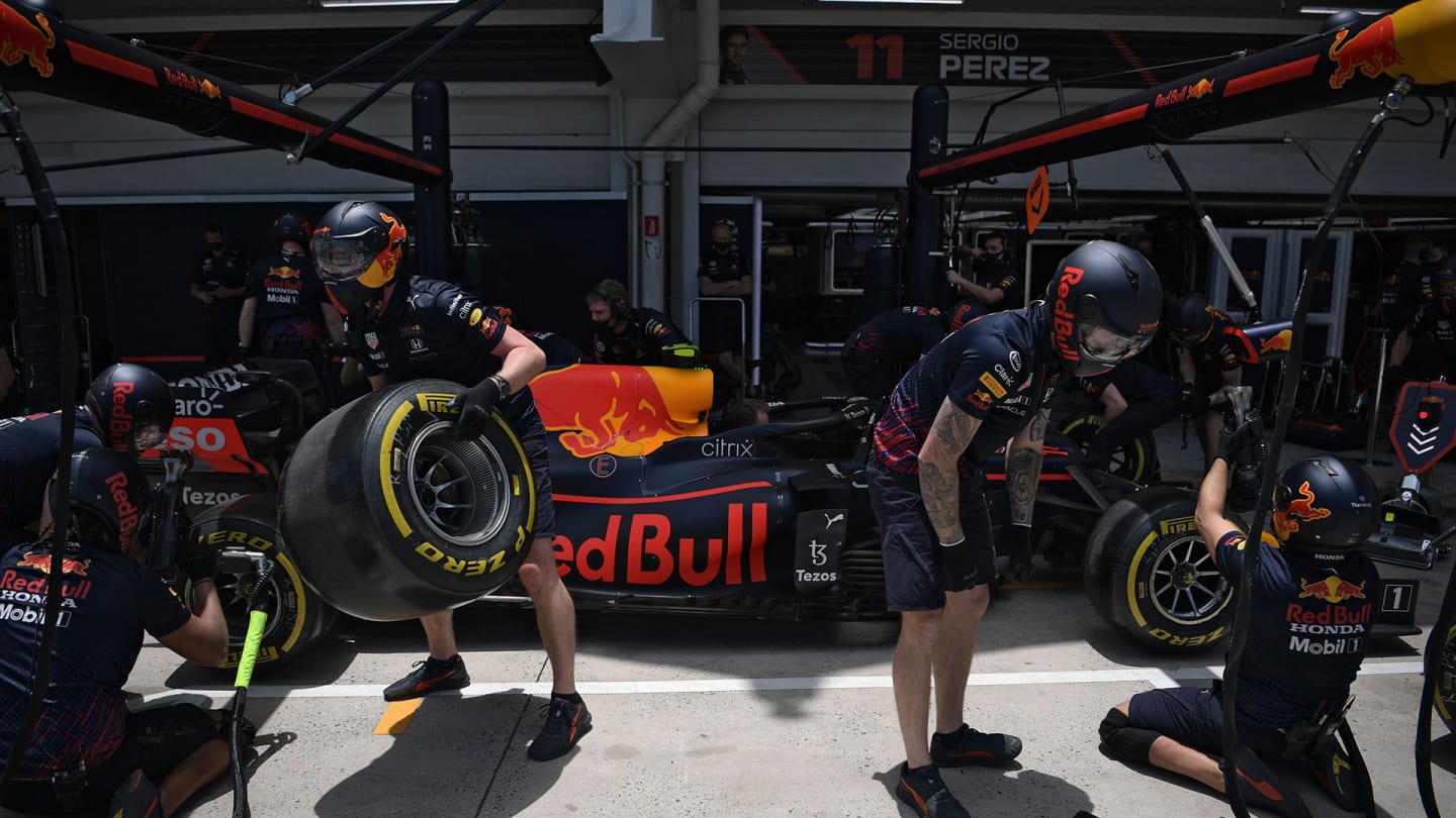 Members of Red Bull's pit crew work during the free practice second session at the Autodromo Jose