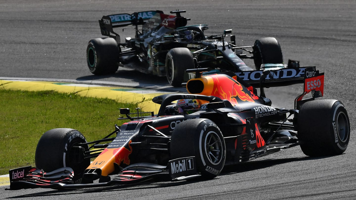 Red Bull's Dutch driver Max Verstappen powers his car ahead of Mercedes' British driver Lewis